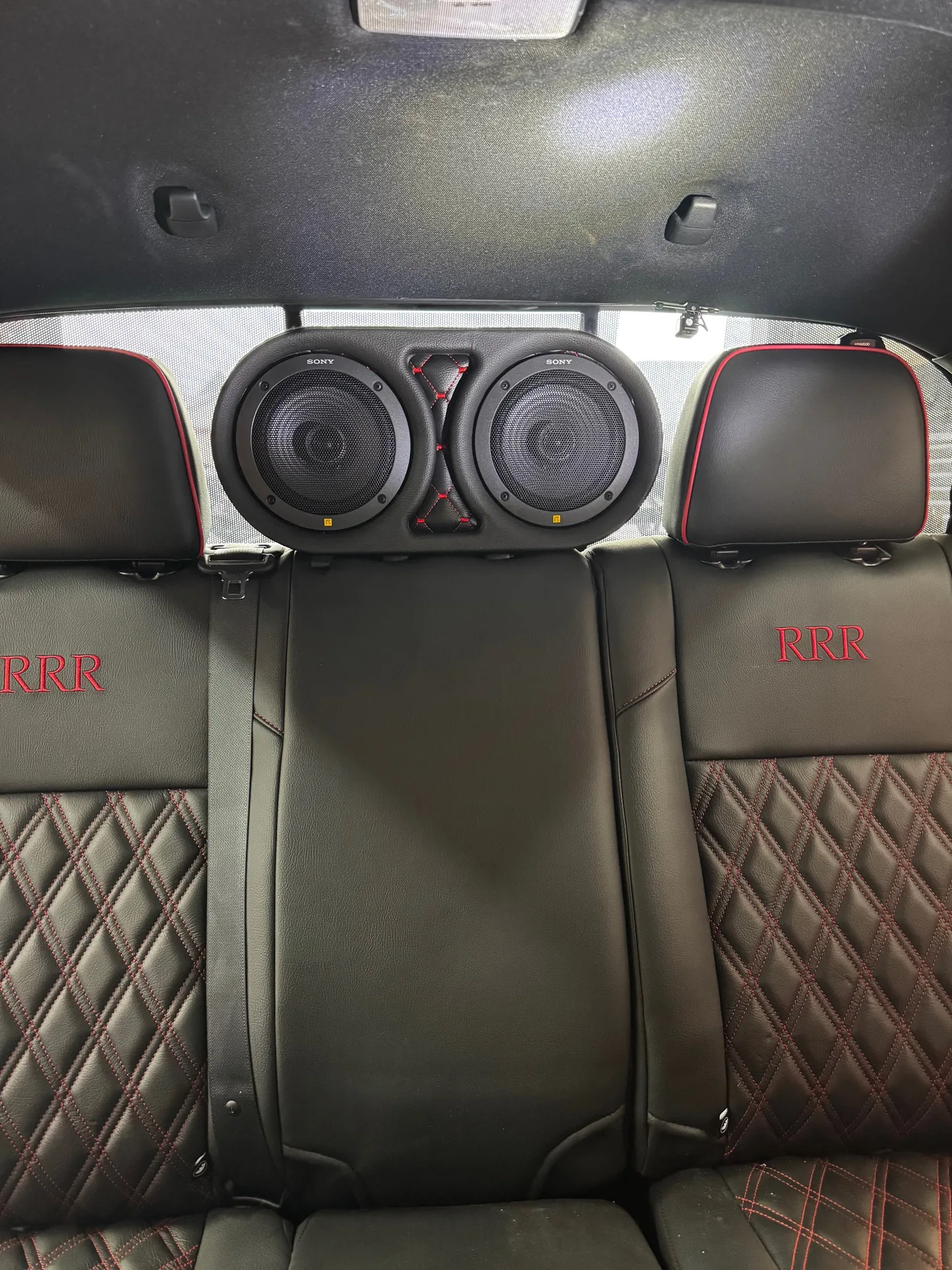 Custom dual rear-seat speaker pods with diamond-stitch panels, 2023 Toyota Tacoma