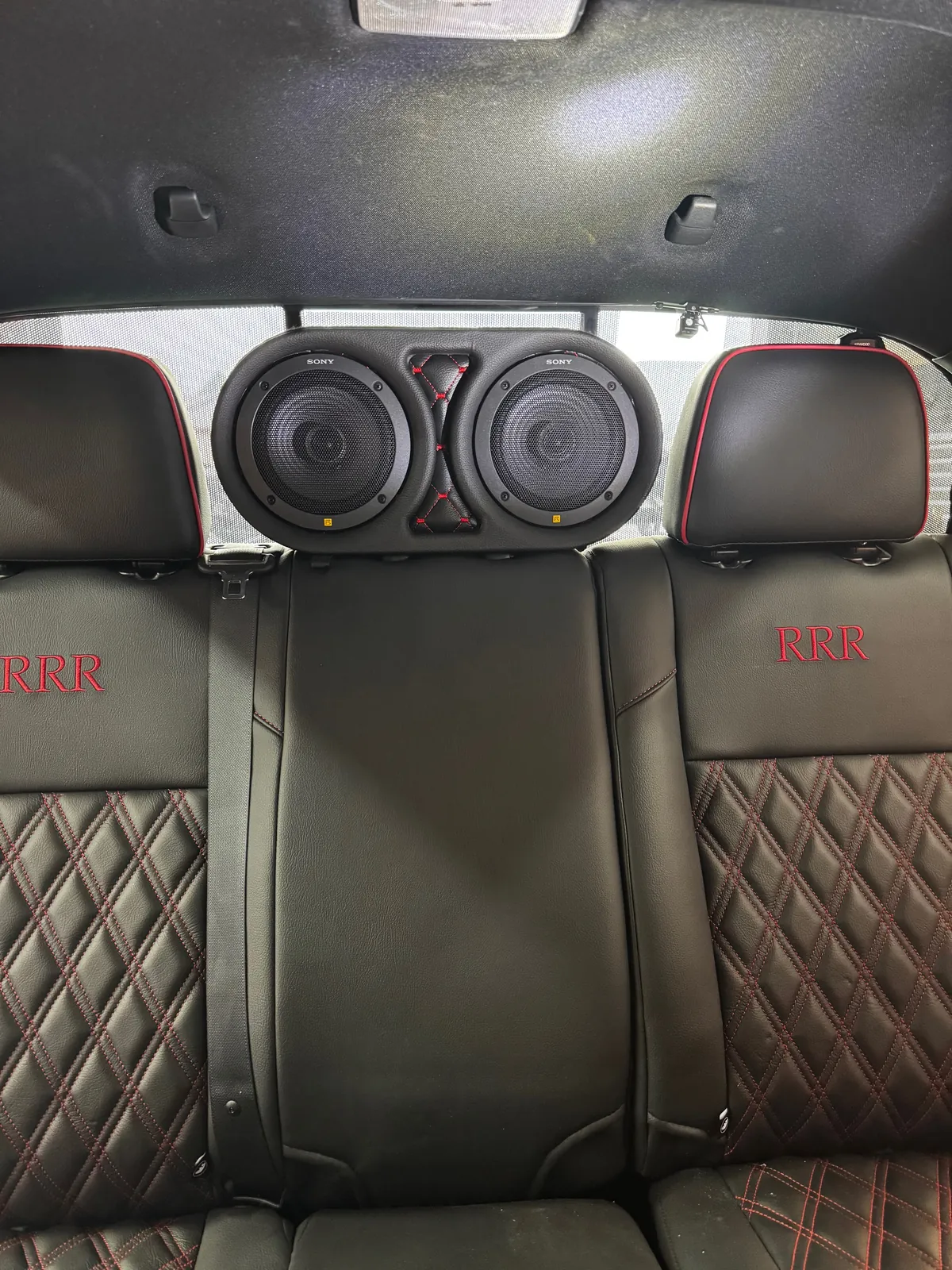 Custom dual rear-seat speaker pods with diamond-stitch panel, 2023 Toyota Tacoma