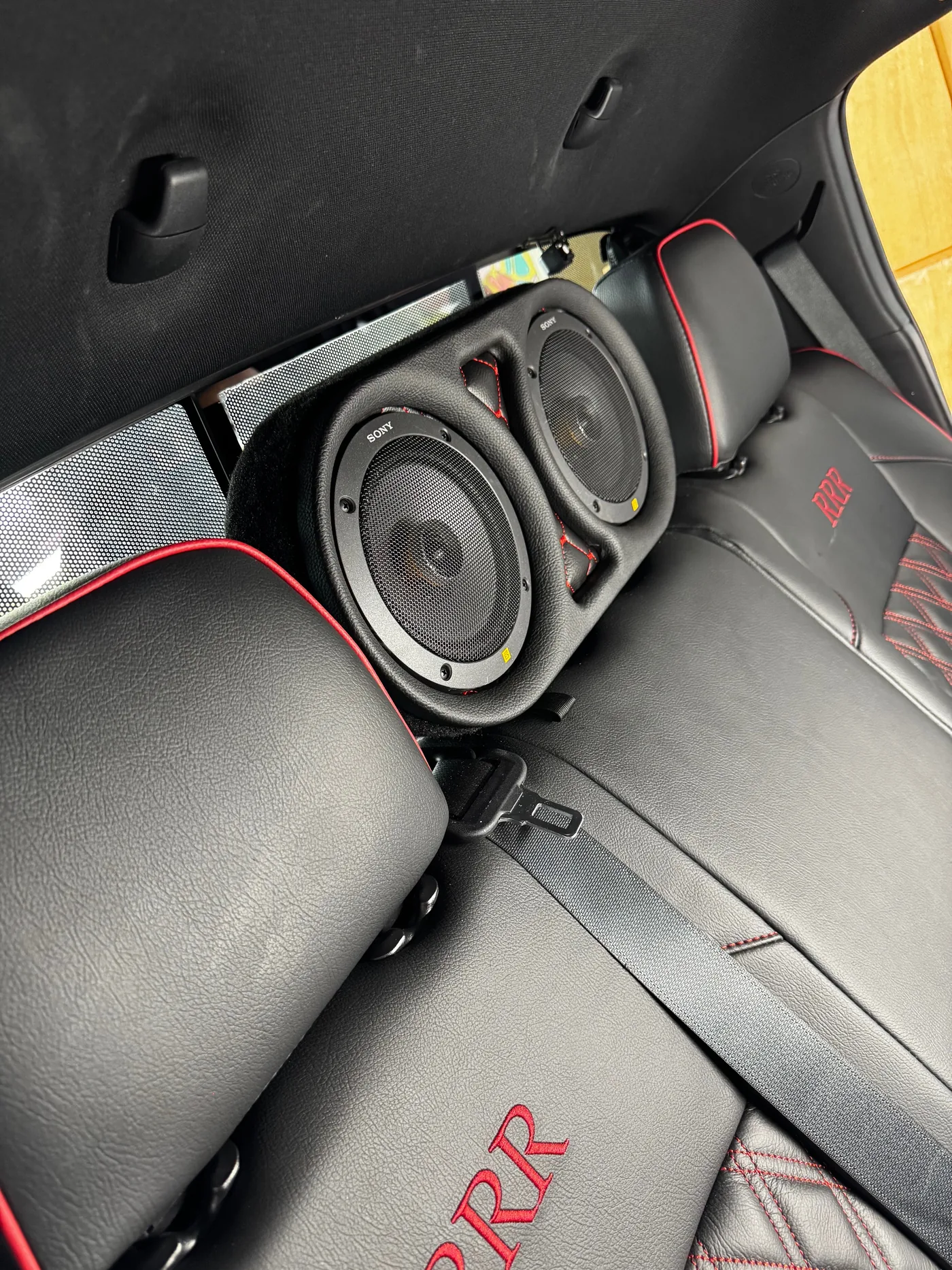 Angled view of custom dual rear-seat speaker pods, 2023 Toyota Tacoma